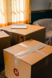 Sunlit room with cardboard boxes, indicating a move or delivery process.